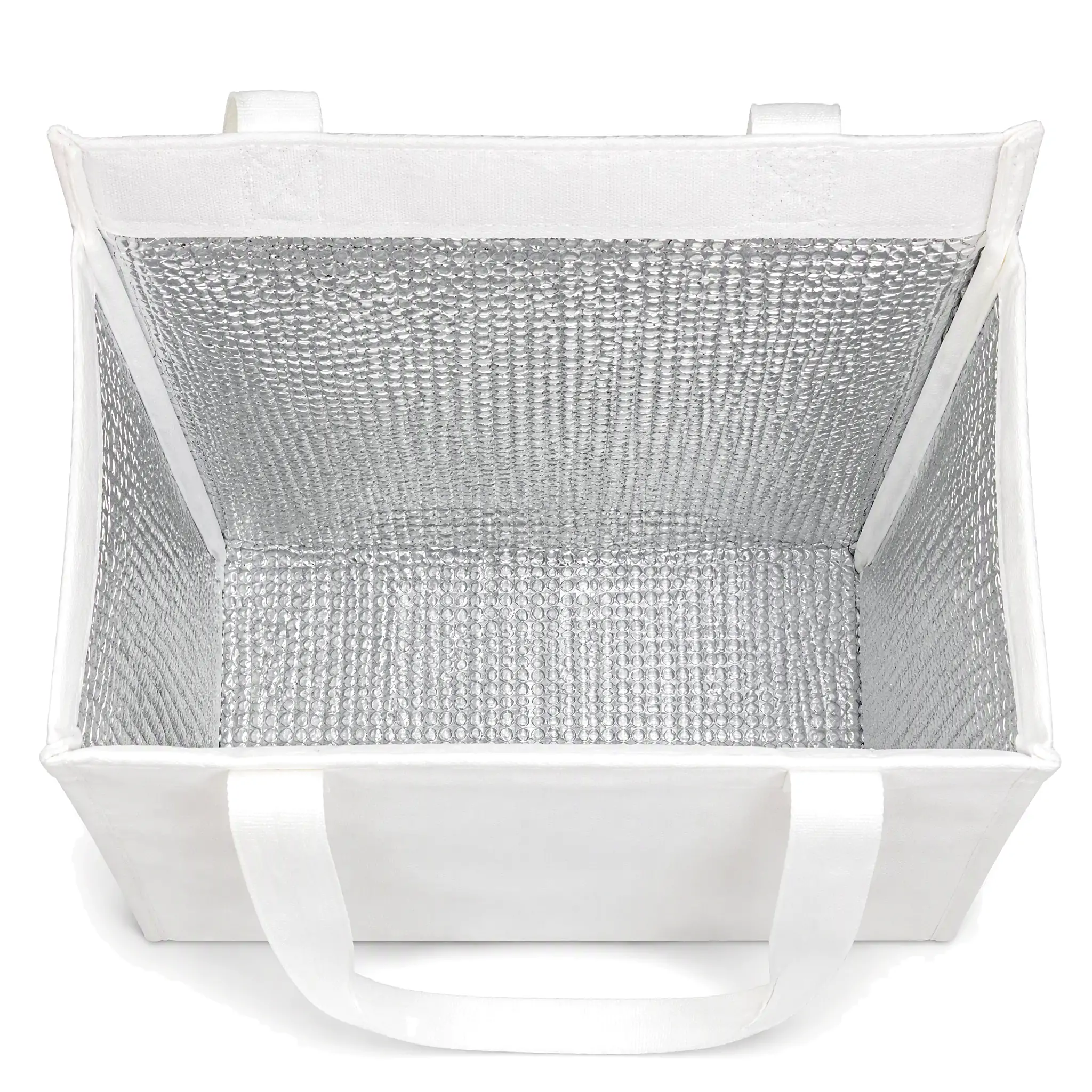 White 10oz canvas insulated lunch bag 25 x 30 x 12 cm with self-fabric handles and a top zipper, standing upright on a wooden desk beside a coffee cup and a sandwich plate