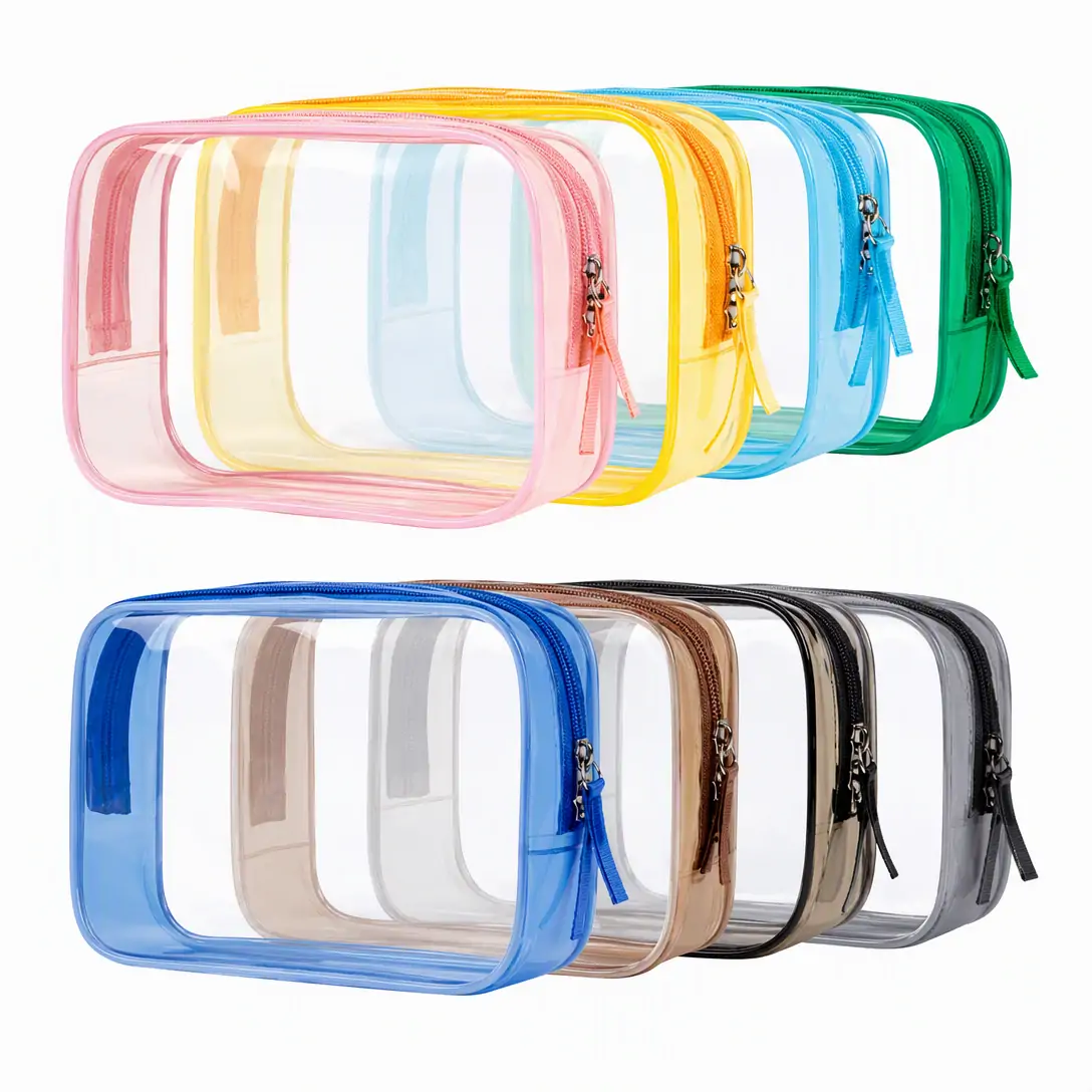 Clear PVC toiletry bag 17 x 12 x 6 cm with pink binding, zip-around closure and fabric pull tab, photographed on a white background with dimension marks