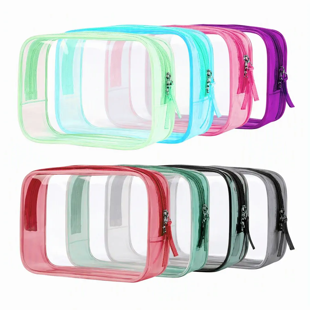Clear PVC toiletry bag 17 x 12 x 6 cm with pink binding, zip-around closure and fabric pull tab, photographed on a white background with dimension marks