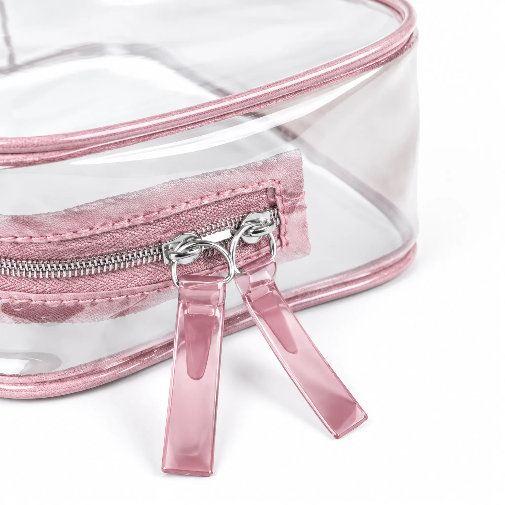 Clear PVC toiletry bag 17 x 12 x 6 cm with pink binding, zip-around closure and fabric pull tab, photographed on a white background with dimension marks