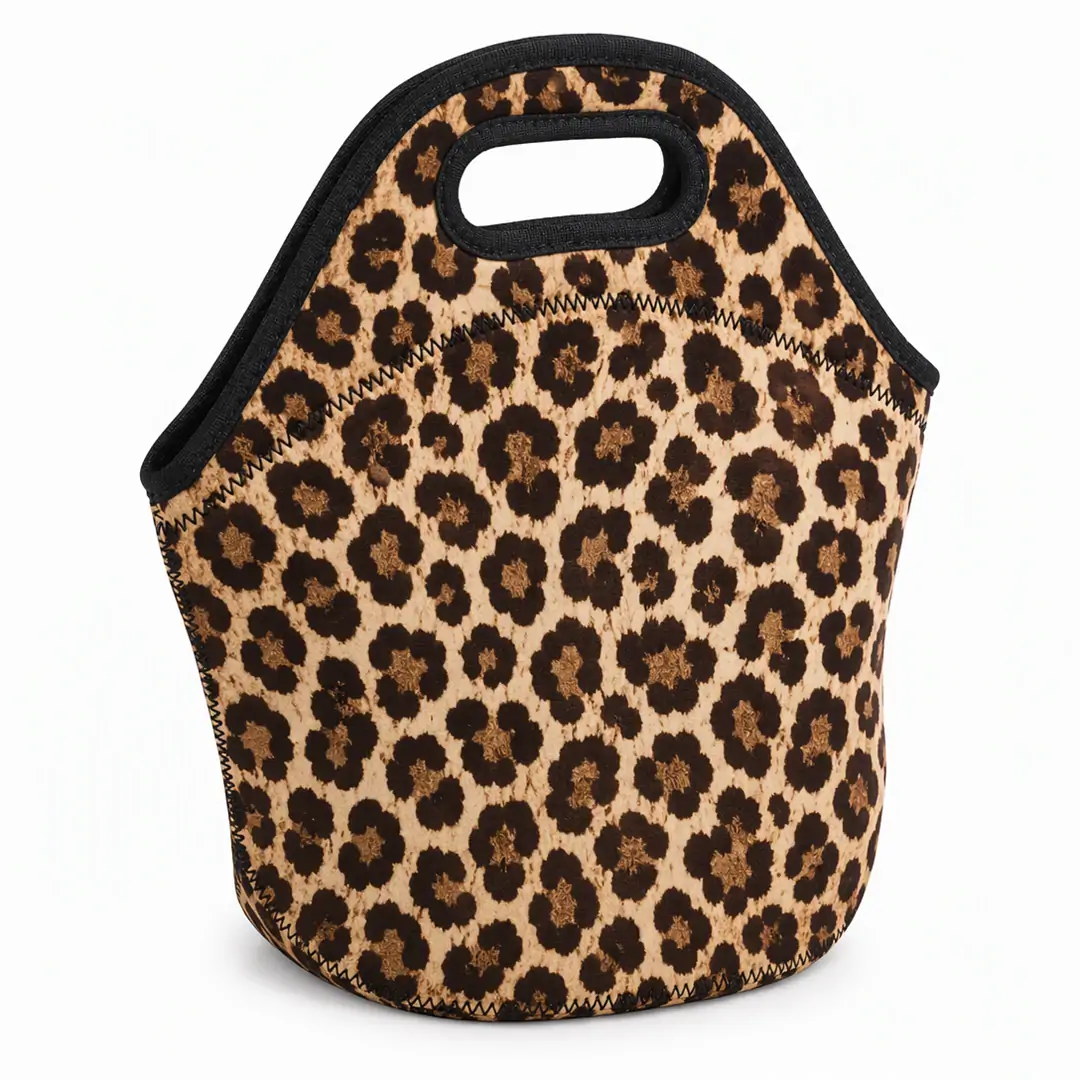 Leopard print neoprene insulated lunch tote 11.3 x 11.8 x 5.5 in with black bound edges, zigzag stitching and an integrated cut-out top handle
