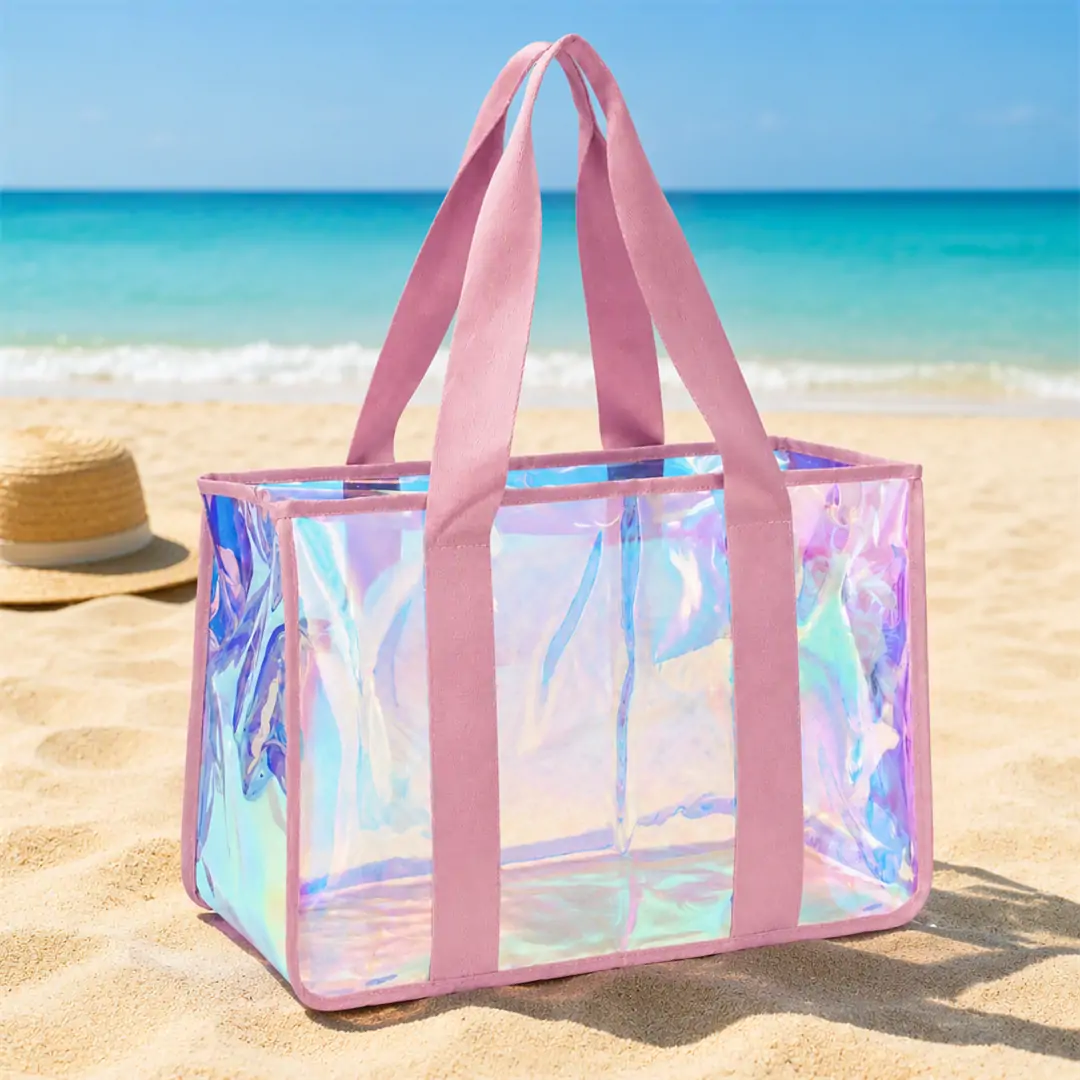 Clear iridescent PVC jelly tote bag 19 x 8 x 12 in with pink jacquard webbing straps and pink bound edges, shown empty on a white background