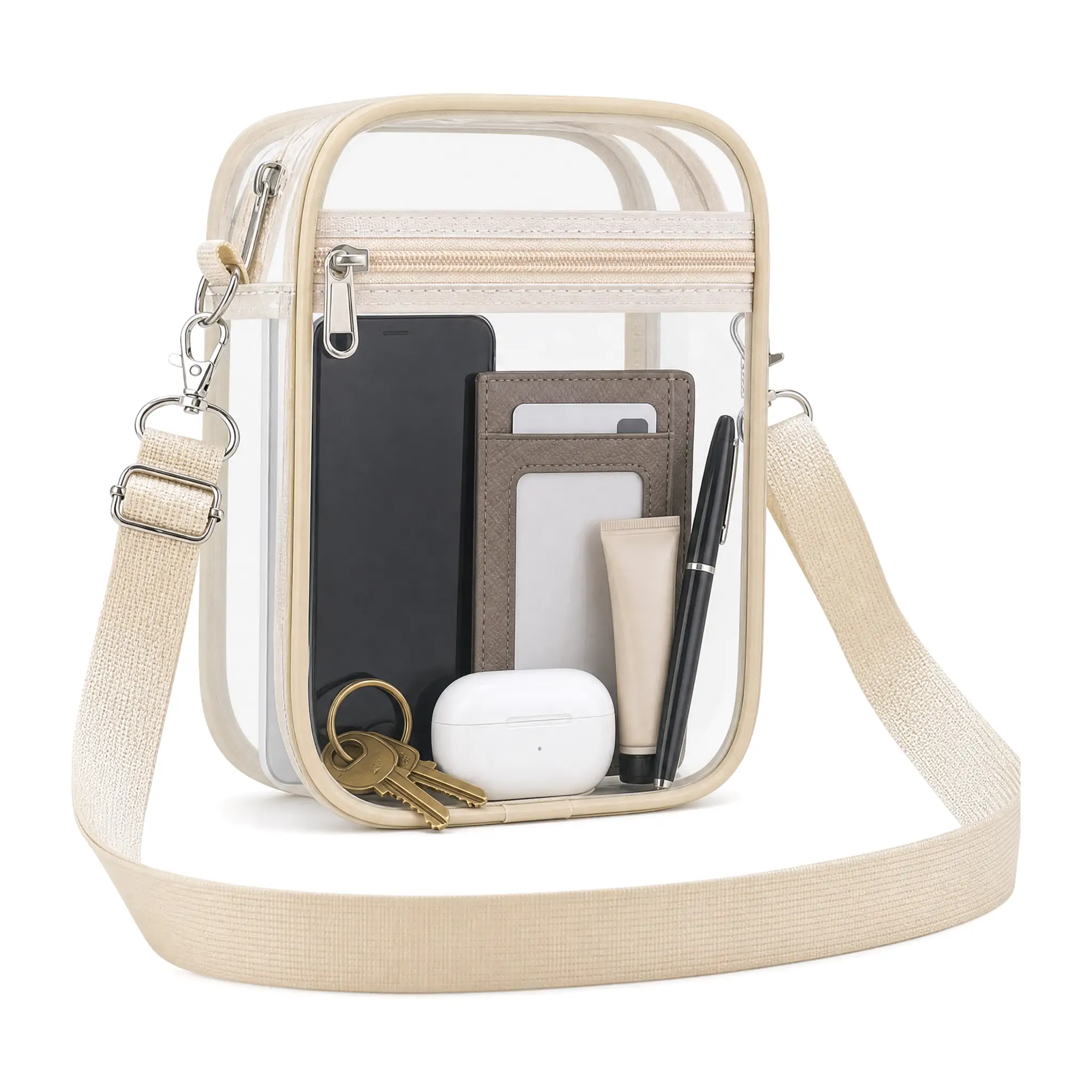 Clear PVC crossbody stadium bag 8.3 x 6.6 x 2.8 in with mint green binding, metal snap-hook strap and two zip compartments, shown filled with cosmetics on a white background